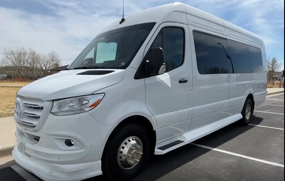 The Denver 16 passenger white Sprinter limo bus