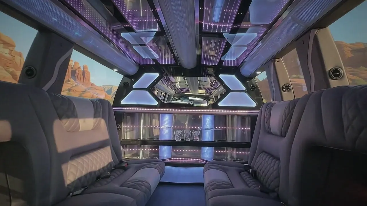 Inside the Cadillac Escalade limo in The Denver: LED light-show ceiling, leather lounge seating and lit bar
